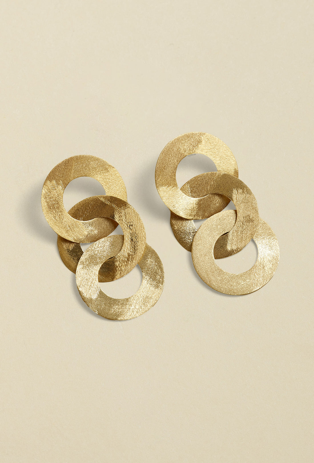 Close-up of gold coated handmade bronze earrings