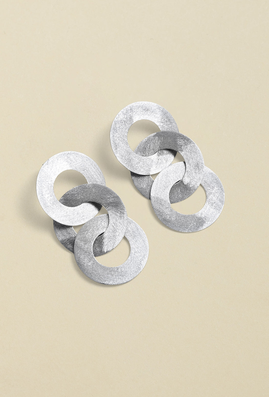 Close-up of silver coated handmade bronze earrings