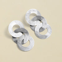 Close-up of silver coated handmade bronze earrings
