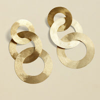 Close-up of gold coated handmade bronze earrings