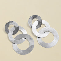 Close-up of silver coated handmade bronze earrings