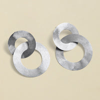 Close-up of silver coated handmade bronze Earrings showcasing intricate craftsmanship and elegant design