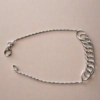 Close-up of a sterling silver chain bracelet, featuring a simple and elegant design with a lightweight feel, perfect for everyday wear