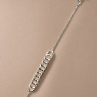 Close-up of a sterling silver chain bracelet, featuring a simple and elegant design with a lightweight feel, perfect for everyday wear