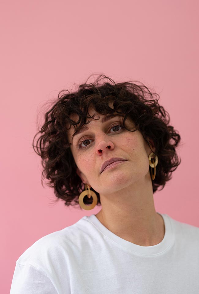 Close-up of a woman with beautiful curly hair wearing Gold Coated Handmade Bronze Earrings