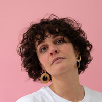 Close-up of a woman with beautiful curly hair wearing Gold Coated Handmade Bronze Earrings