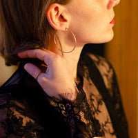 Bronze-colored handmade bangle worn by a stylish woman