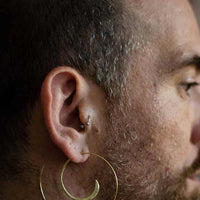 Close-up of Gold-Coated Handmade Silver Creoles Adorning a Bearded Men's Ear
