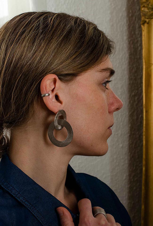 Close-up of a woman with wearing silver Coated Handmade Bronze Earrings