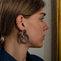 Close-up of a woman with wearing silver Coated Handmade Bronze Earrings