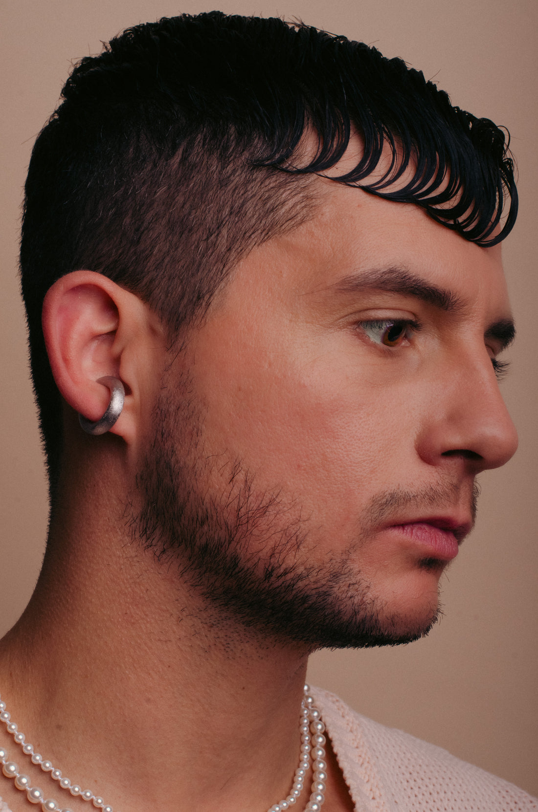 close up of a man wearing a silver coated cuff