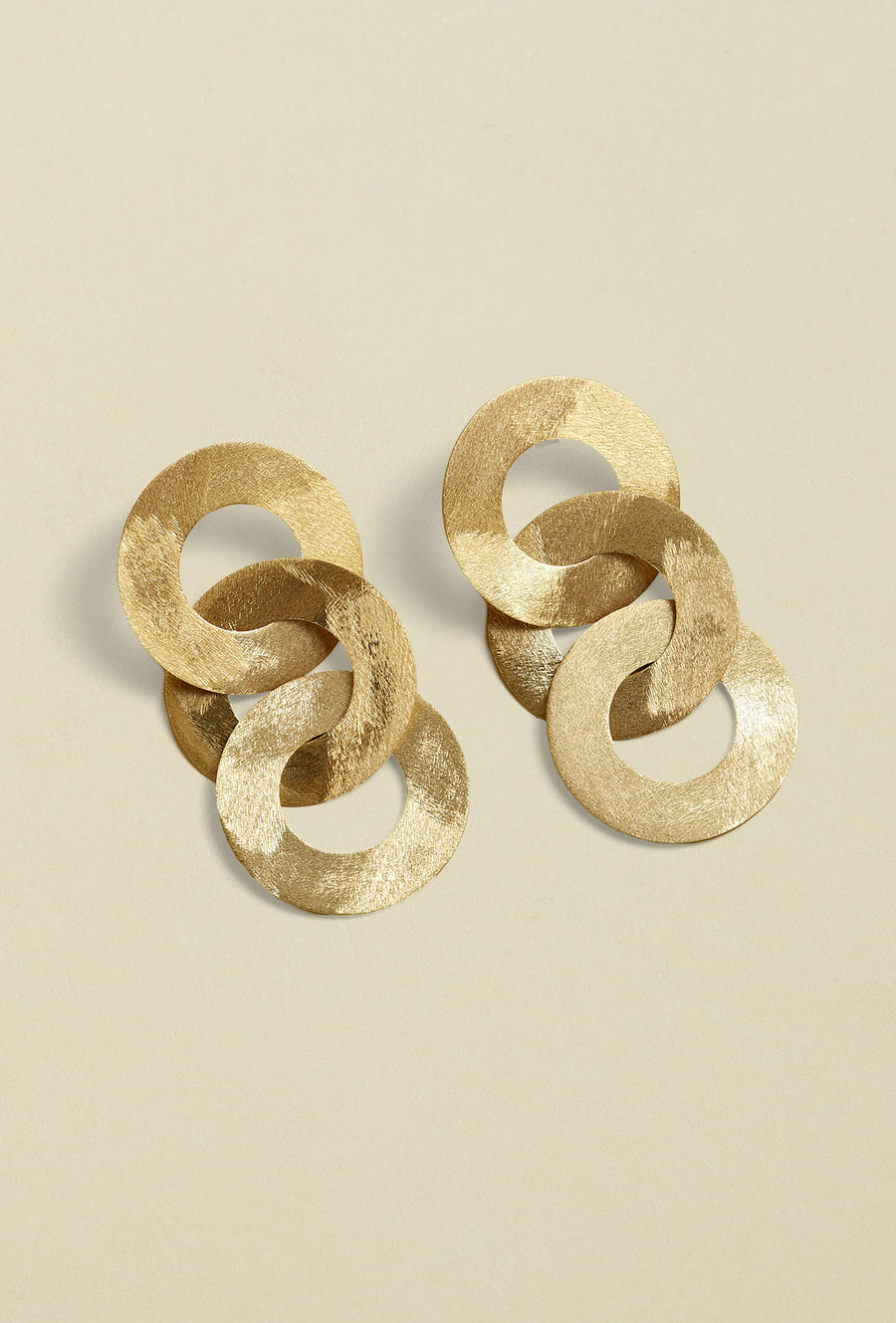 Close-up of gold coated handmade bronze earrings