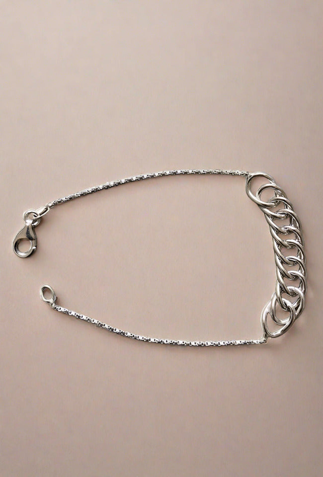 Close-up of a sterling silver chain bracelet, featuring a simple and elegant design with a lightweight feel, perfect for everyday wear