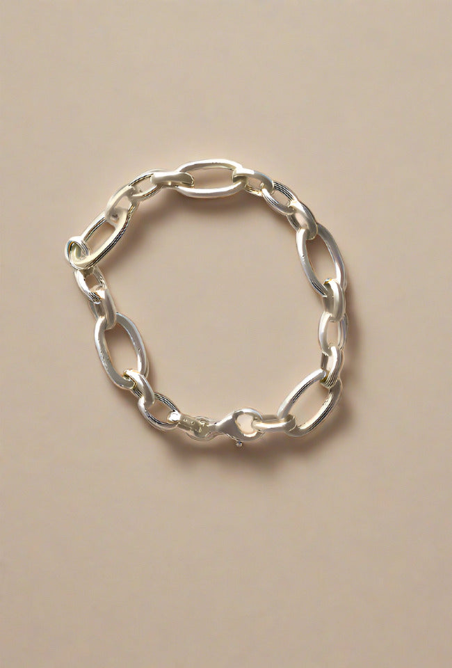 Silver bracelet with a bold, modern chain design.