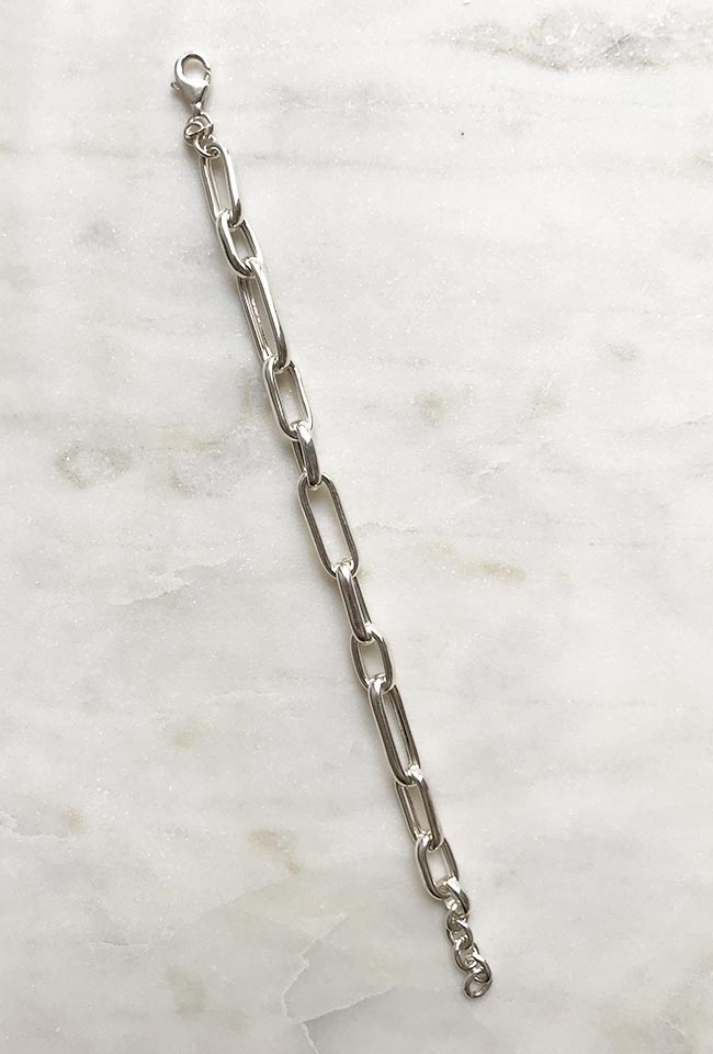 Silver bracelet with a bold, modern chain design.