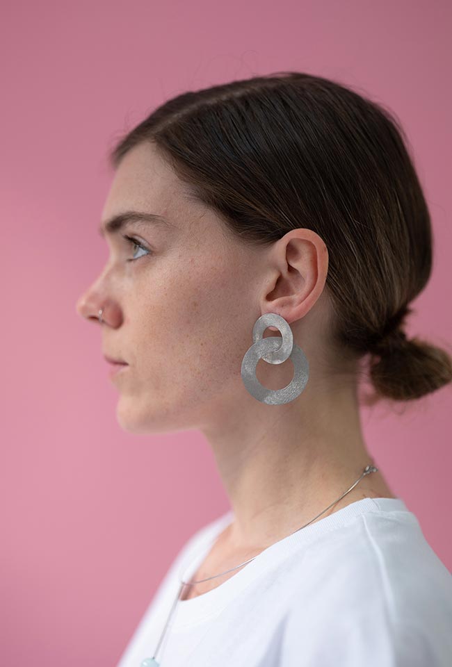 Close-up of a woman with wearing silver Coated Handmade Bronze Earrings