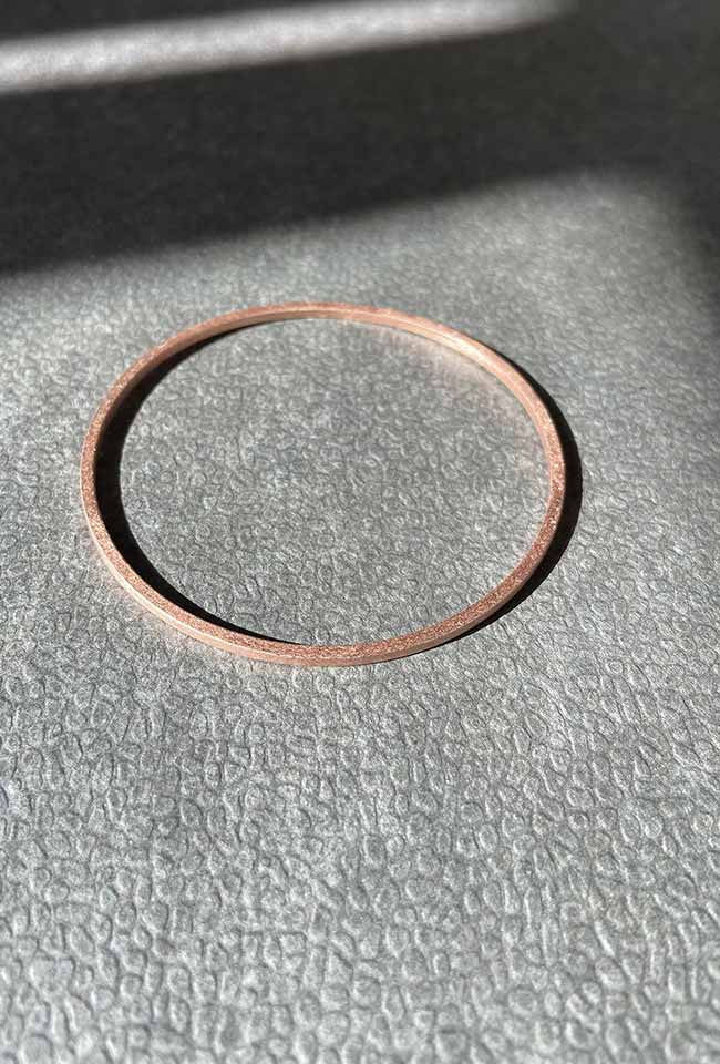 Handcrafted bronze bangle with a bronze coloring