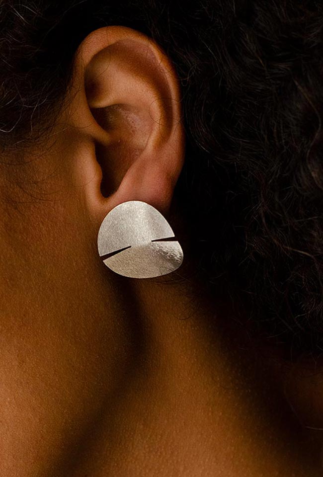 Close-up of a woman's ear adorned with a stunning sterling silver earring