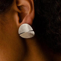 Close-up of a woman's ear adorned with a stunning sterling silver earring