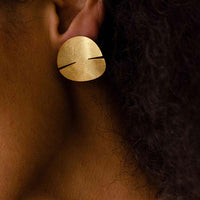 Close-up of a woman's ear adorned with a stunning sterling gold covered silver earring